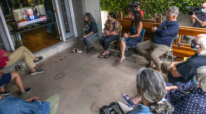 A group gathers at a home to watch a speech by President Joe Biden on the ending of the war in Afghanistan in Long Beach Tuesday, August 31, 2021. Photo by Thomas R. Cordova.